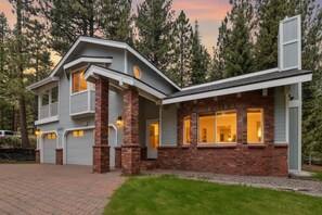 A two-story house with a brick facade, large windows, and a garage. - Minutes to Heavenly, Private Covered Hot Tub (South Lake Tahoe)