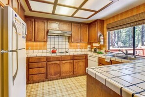 Fridge, microwave, oven, stovetop - Tahoe Cabin with Stone Fireplace, 2-Car Garage & Fenced Yard — Steps to the River (South Lake Tahoe)