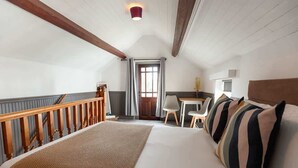 A bedroom with a bed, a desk, and a chair. - 5-Bed North Wales Escape with Hot Tub & Views (Mochdre)