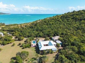 An aerial view of a property with a swimming pool, multiple buildings, and lush greenery. - Southfork is a Caribbean estate where luxury, space, and privacy come togethe (St Paul)