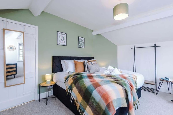 A comfortable bedroom with a king-size bed that can be easily separated into two single beds. The room has soft lighting, cozy bedding, and a calm atmosphere for a relaxing stay
