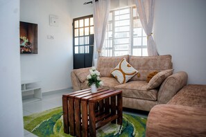 Living area - Serene 1-bedroom apartment, walking distance to Diani Beach with AC and a pool. (Diani Beach)