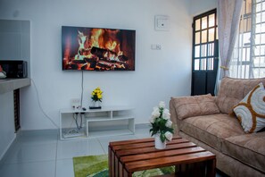 Living area - Serene 1-bedroom apartment, walking distance to Diani Beach with AC and a pool. (Diani Beach)