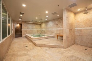 A spa room with a hot tub, a bench, and a shower area. - Luxe 3BR in Village, Hot Tub, Pool, Sauna, Parking (Vail)
