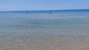 A beach with clear water and a distant horizon. - A two-storey wooden villa fully equipped with all amenities with Love (Durrës)