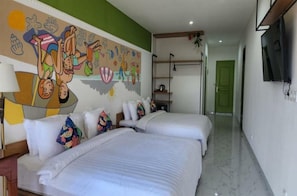 A hotel room with two beds, a mural, a TV, and a green door. - Spacious Family Suite Perfect for Group Stay (Bali)