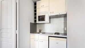 A compact kitchen with a microwave, sink, and dishwasher. - Chic Light-Filled Pool Oasis in Grasse (Grasse)