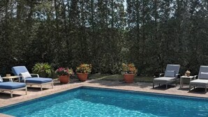 A rectangular swimming pool with clear blue water, surrounded by hexagonal tiles. - Home 2 mins. from Shinnecock Golf town SH beaches (Southampton)