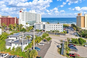 A coastal hotel with multiple buildings, parking areas, and a view of the ocean. - Pompano Studio | Heated Pool | Across from Beach (Pompano Beach)