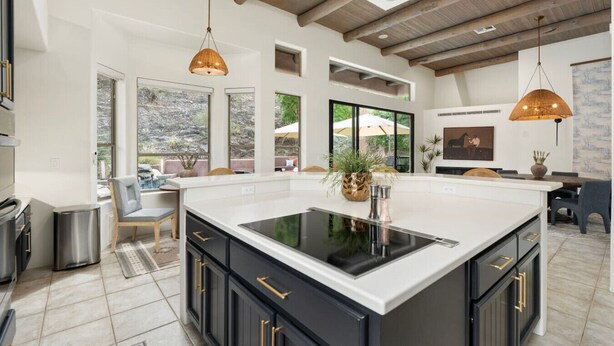 A spacious kitchen with a large island, pendant lighting, and a view of the outdoors. - NEW | HTD Pool | Firepit | Biltmore | Piestewa (Phoenix)