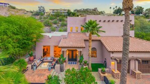 A multi-story house with a patio area, palm trees, and a view of surrounding buildings. - NEW | HTD Pool | Firepit | Biltmore | Piestewa (Phoenix)