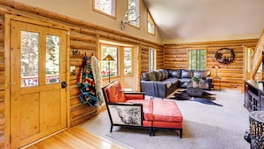 A log cabin interior with a wooden floor, a leather sofa, a red armchair, and a fireplace. - Rebels Retreat-Minutes from Main St, Longtime Guest Favorite now with IronStone! (Ouray)
