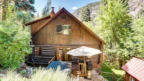 A rustic log cabin with a wooden deck, a grill, and a large umbrella. - Rebels Retreat-Minutes from Main St, Longtime Guest Favorite now with IronStone! (Ouray)