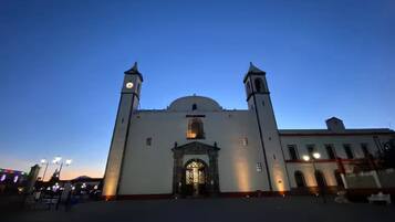 A large building with two towers and a central dome, featuring a prominent entrance with a decorative arch.