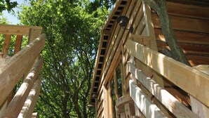 A wooden staircase leading up to a building with a wooden exterior. - Beautiful handbuilt Treehouse sleeps 2-6 (Wootton Bridge)