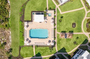 An aerial view of a resort with a swimming pool, sun loungers, and a small pool area. - Sanibel Beach Club 2 Beachfront 2BR Escape (Sanibel)