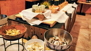 A buffet setup with various food items and condiments.