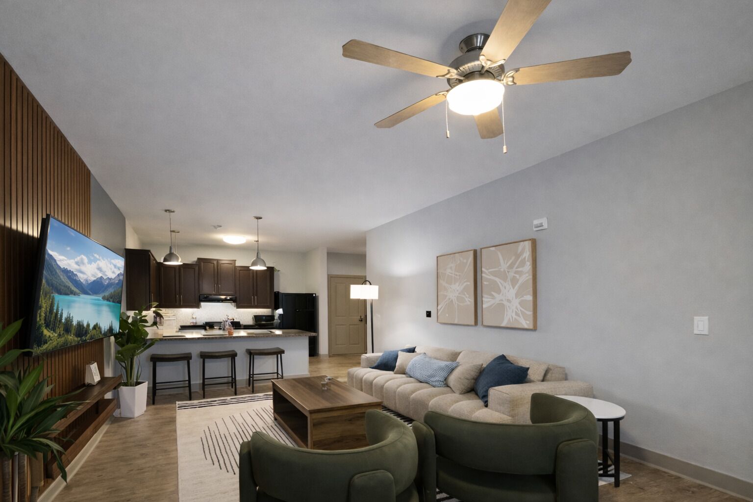 A modern living room with a sofa, coffee table, and a ceiling fan.