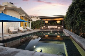 A swimming pool with lounge chairs and a covered seating area. - La Jolla Luxury | Designer Home w/ Pool & Jacuzzi! (San Diego)