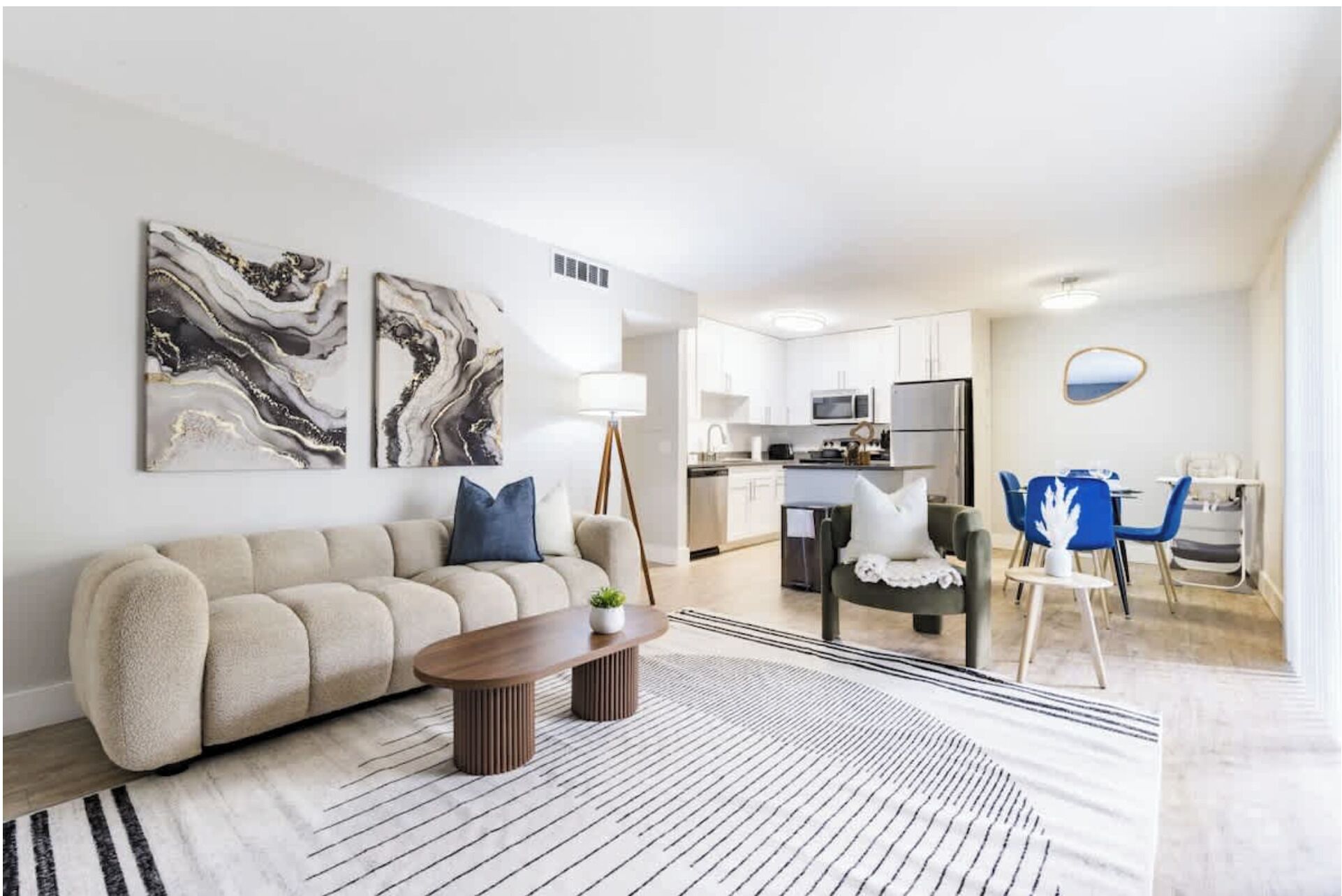 A modern living room with a sofa, coffee table, and artwork.