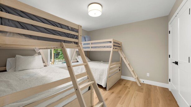 A bunk bed room with a ladder, a window, and a door. - 40’ Boat Slip-New Luxury Lakefront-3 King Beds-Sleeps 12-21MM (Osage Beach)