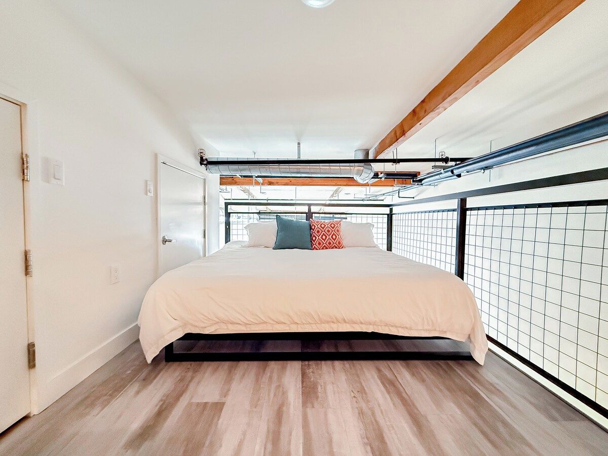 A bedroom with a bed, a window, and a view of the outdoors.