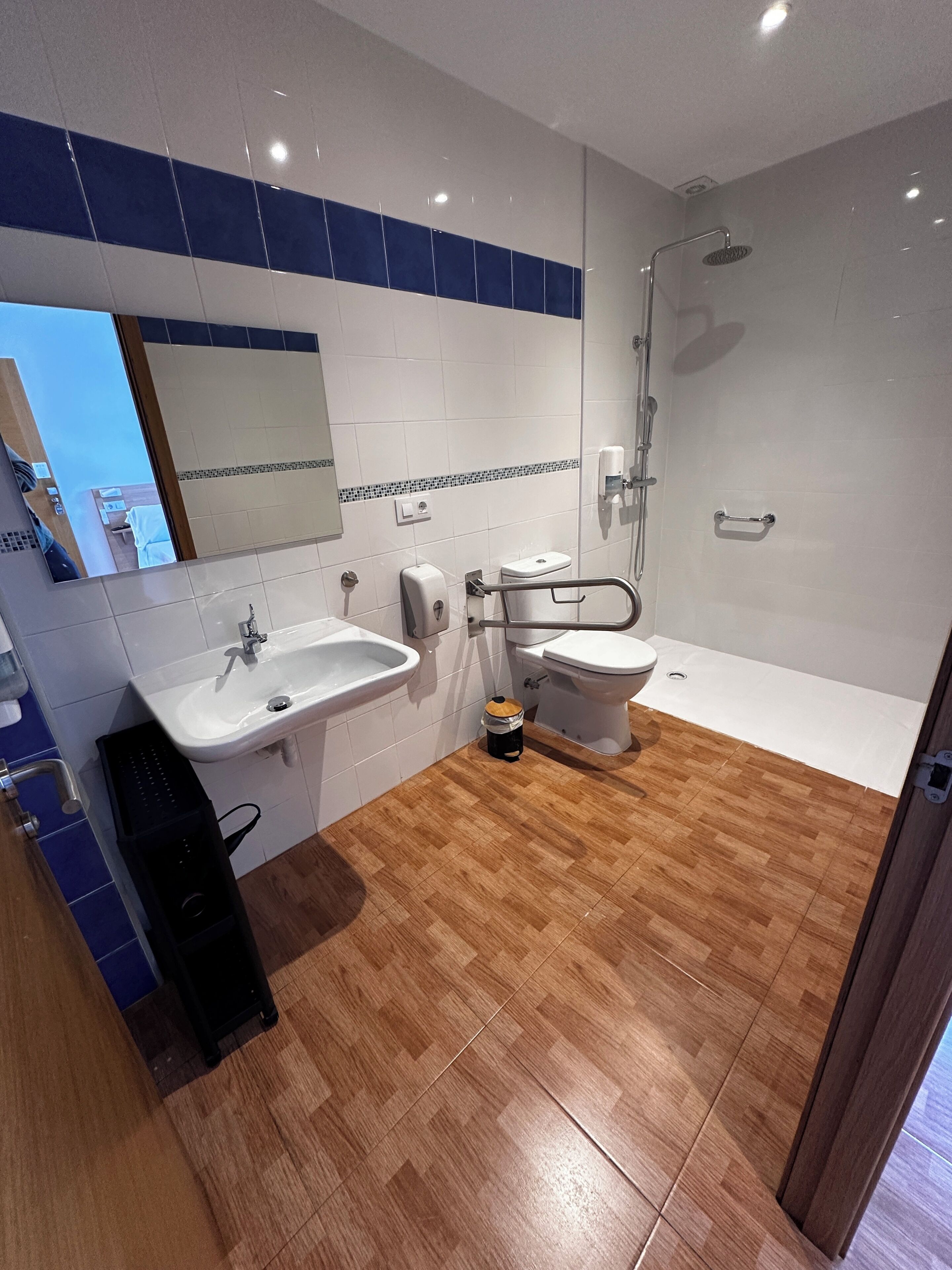 A modern bathroom with a sink, toilet, and shower.