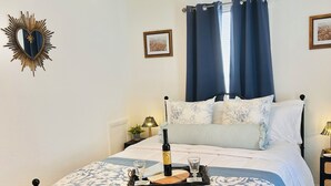 A neatly arranged bedroom with a bed, bedside tables, a lamp, a mirror, and a ceiling light fixture. - “Up in the hill” is a charming, 1 bedroom apartment located in Haines City (Haines City)