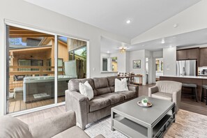 A modern living room with a sofa, coffee table, and a dining area with chairs. - Ctc3k3 (Keystone)