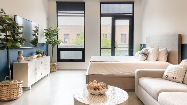 A modern bedroom with a bed, a sofa, a TV, and a large window. - 5 Miles to Disney & Airport w/ Gym Pet friendly (Santa Ana)