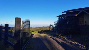 A gated entrance to a property with a clear view of the surrounding landscape.