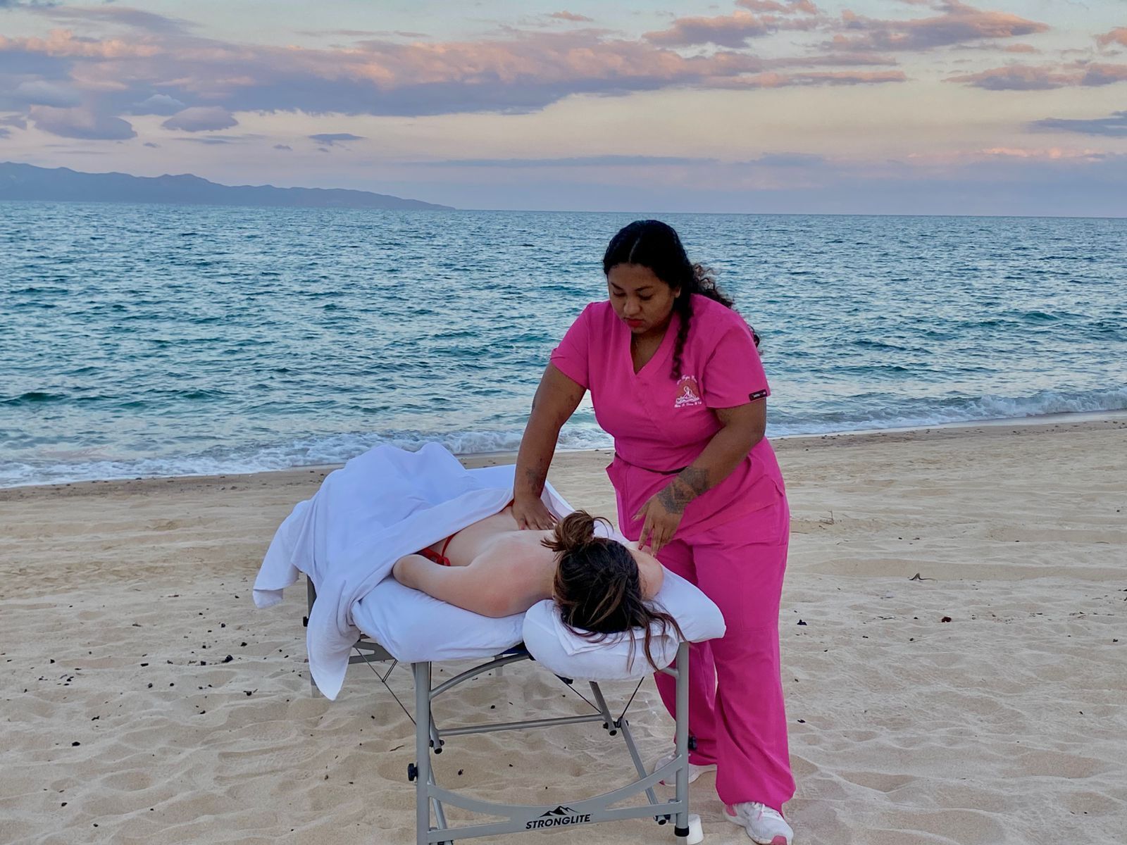 On the beach, white sand, beach towels, beach massages