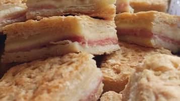 A close-up of a food item, possibly a pastry or dessert, with layers visible inside.