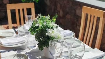 A table set for dining with a mountain view in the background.