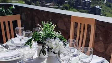A table set for dining with a mountain view in the background.