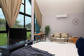 A modern hotel room with a large bed, a flat-screen TV, a sofa, a dining table, and a view of the outdoors. - 3BR Pool Villa · Granary Villas · Bangtao | CapitalPro (Bangtao)