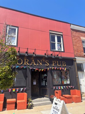 A building with a black awning and a sign reading 'MORAN'S PUB'.