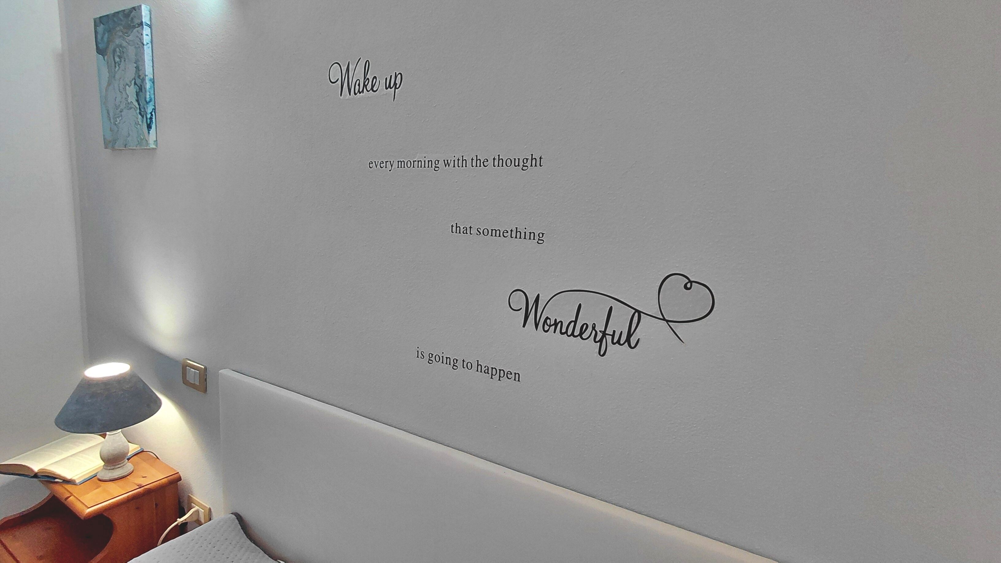 A wall with motivational text and a heart symbol.