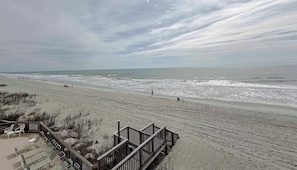 A beach with a wooden walkway leading to beach chairs and a lifeguard sign. - Maritime Place A5 - Oceanfront in Garden City Beach (Garden City Beach)