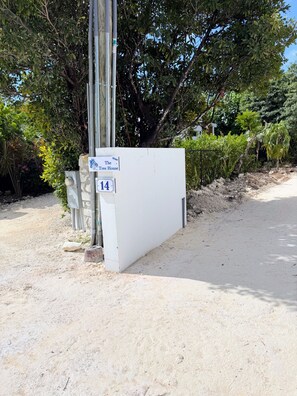 A white building with a sign reading 'The White Tree House' and the number 14. - NEW Luxury Grace Bay villa,Pool,2 min>Beach&Reef (The Bight Settlement)