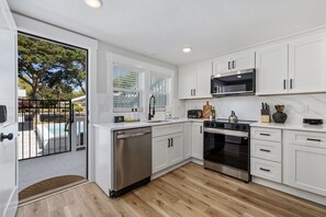 Fridge, microwave, oven, stovetop - Sea Breeze - 6BR Coastal Escape w/ Heated Pool + Dual Kitchens (Walk to Beach!) (North Myrtle Beach)