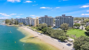 A coastal hotel with multiple high-rise buildings, a beach, and a clear sky. - Gemini Resort 55 Stunning Ocean Views (Golden Beach)
