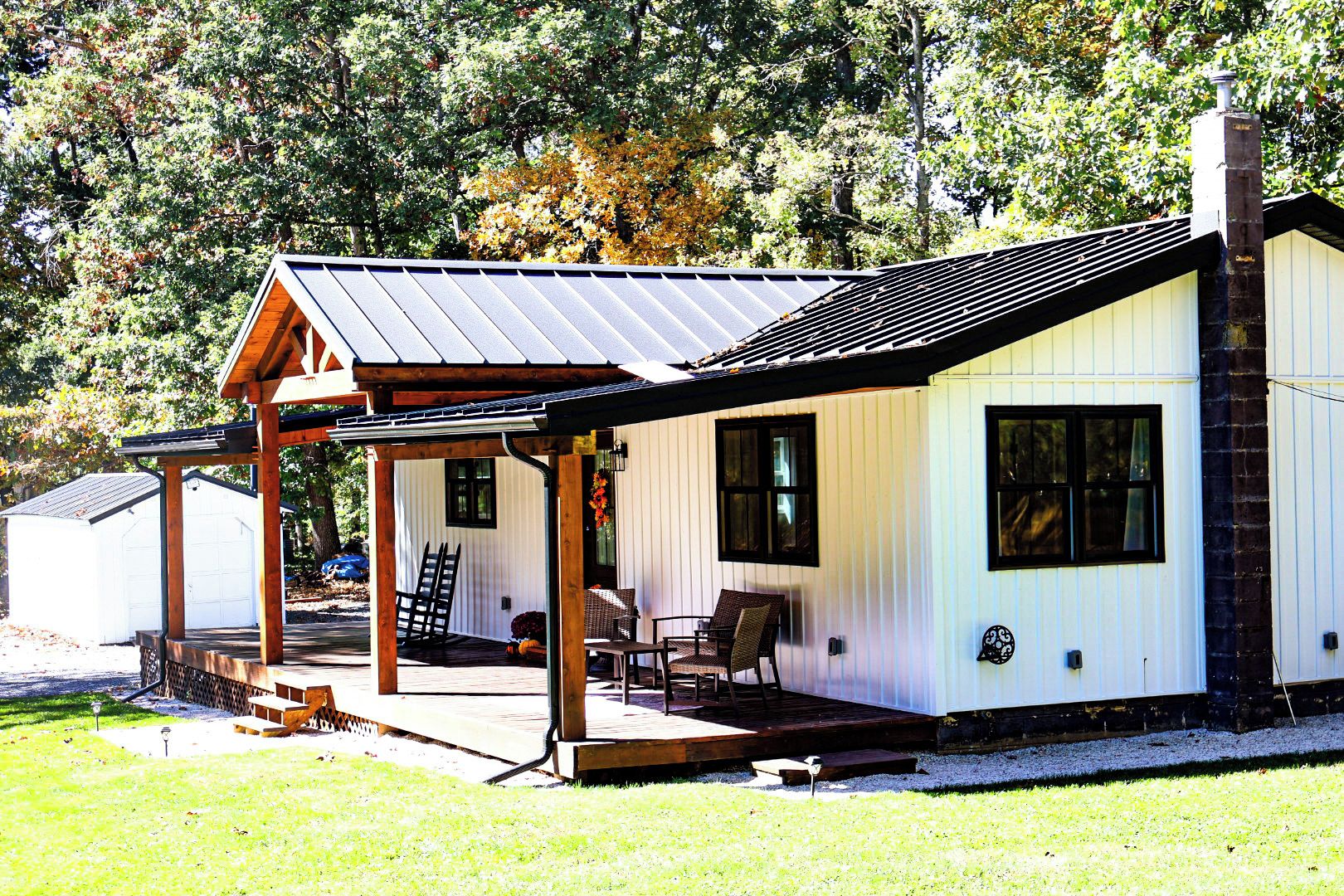 A single-story house with a covered porch, a chimney, and a garage.