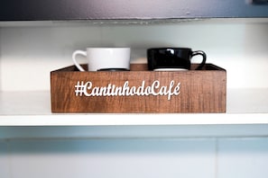A wooden tray with two cups and a hashtag sign.