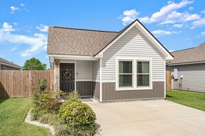 A single-story house with a front porch, a garage, and a well-maintained lawn.