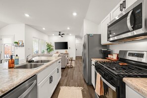 A modern kitchen with a built-in microwave, stove, and refrigerator.