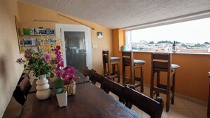 A dining area with a wooden table, chairs, and potted plants. - Lovely Apartment Vrsar 8 With Terrace, Vrsar, Croatia (Vrsar)