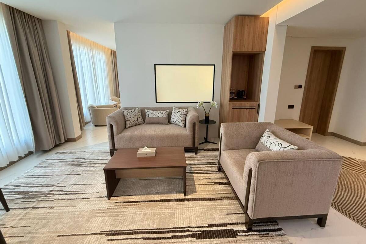 A modern living room with two sofas, a coffee table, and a TV.