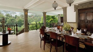 A dining area with a view of lush greenery, wooden furniture, and hanging lanterns. - 5 Bedroom Villa in Ubud with Jungle view (Ubud)