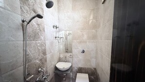 A bathroom with a shower, sink, and toilet. - Hotel SR Executive Akola (Akola)